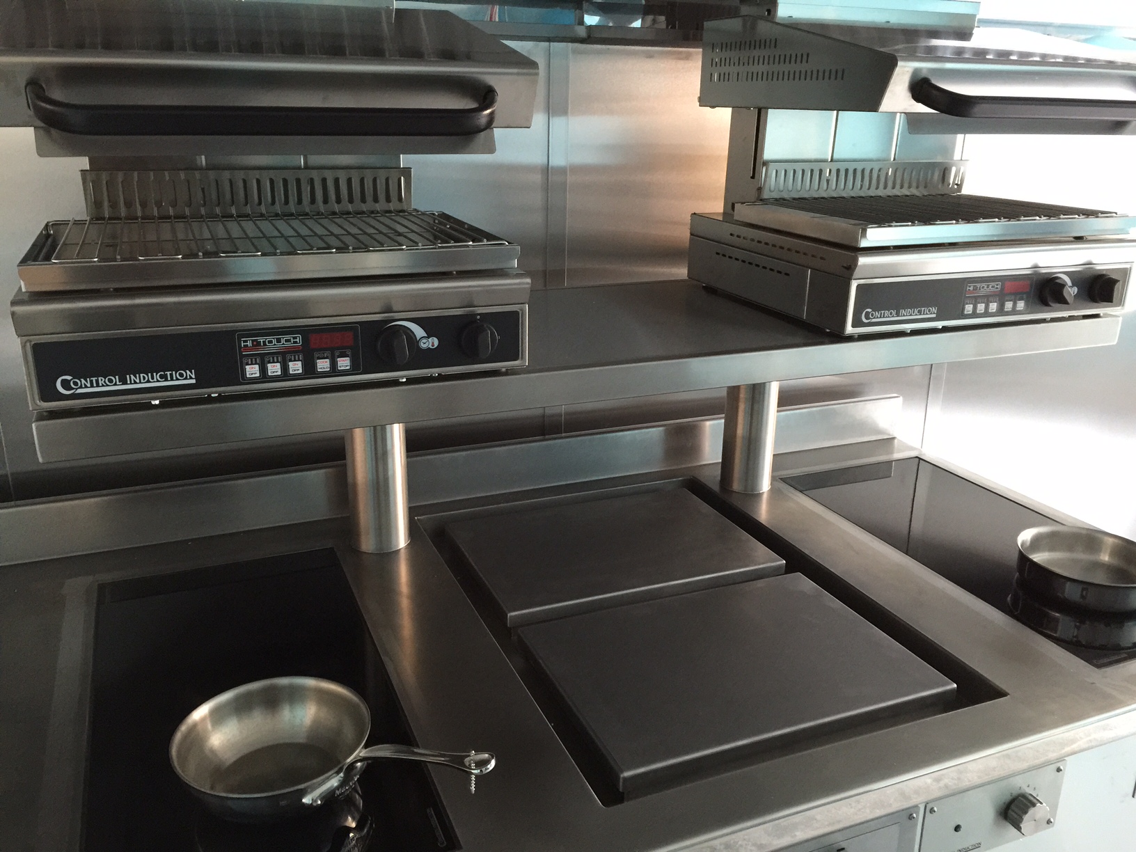 Induction cooking suite with salamanders over