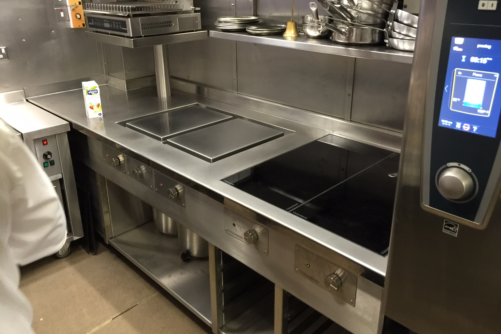 Finished induction cooking suite next to combi oven